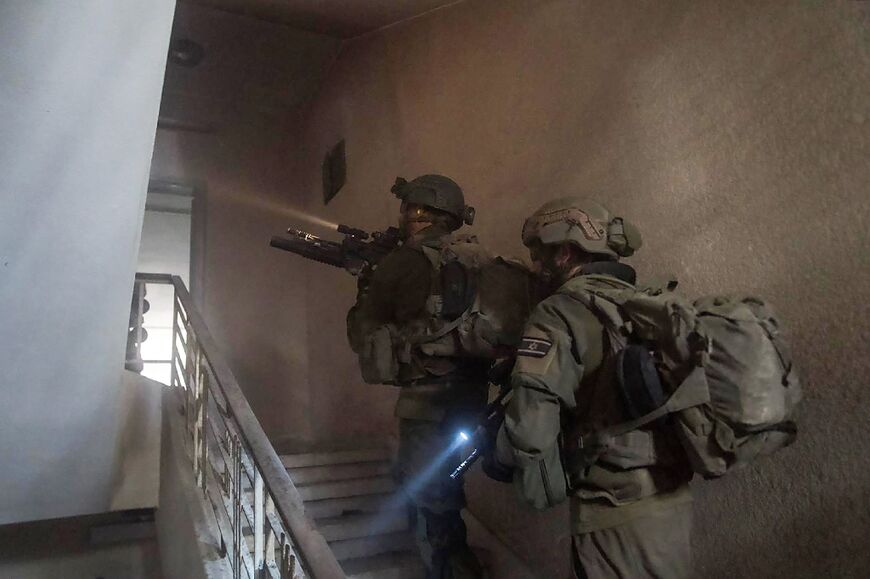 A picture released by the Israeli army shows Israeli soldiers during a military operation inside a building in the Gaza Strip