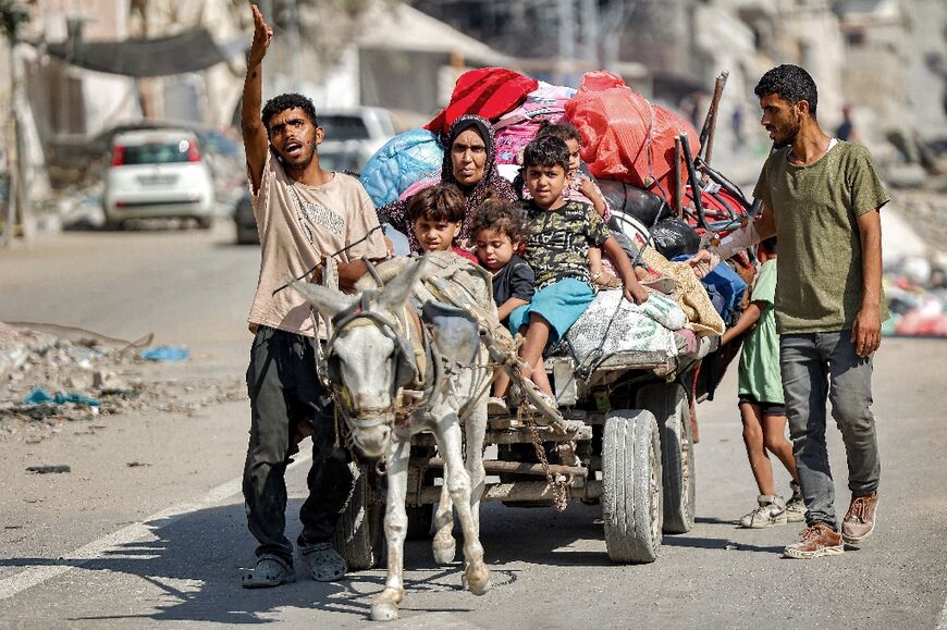 A family and its belongings in Gaza City's Al-Tuffah district, which witnesses said they were told to flee