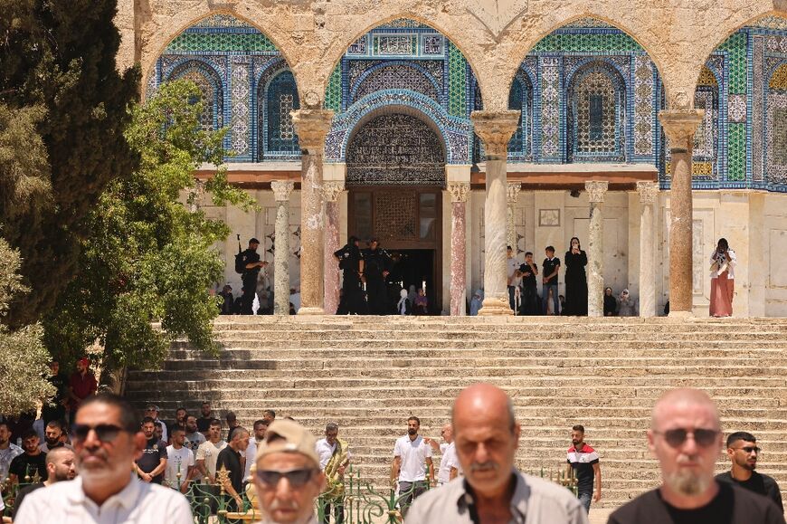 Israeli police stand guard as Muslims perform Friday prayers at the Dome of the Rock mosque in Jerusalem's Al-Aqsa compound