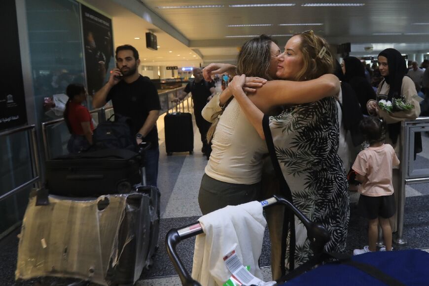 People hug at the arrivals area of Beirut International Airport