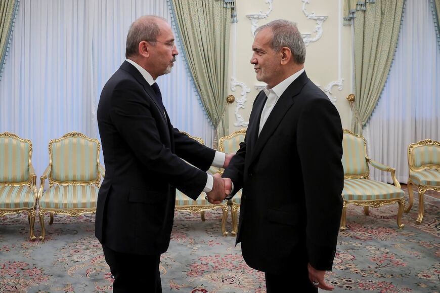 A handout picture showing Jordan's Foreign Minister Ayman Safadi meeting Iranian President on a rare visit to Tehran