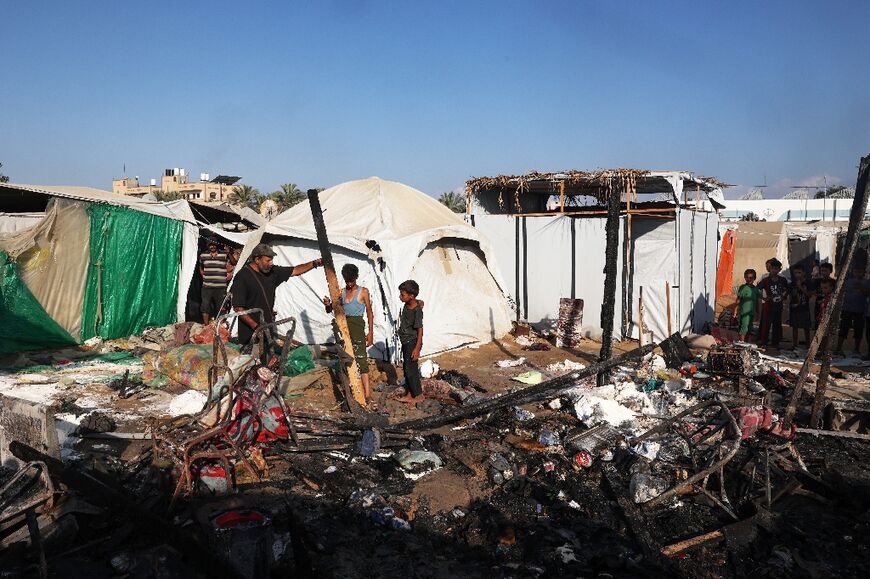 The aftermath of an overnight strike that hit tents used as temporary shelters by displaced Palestinians in central Gaza