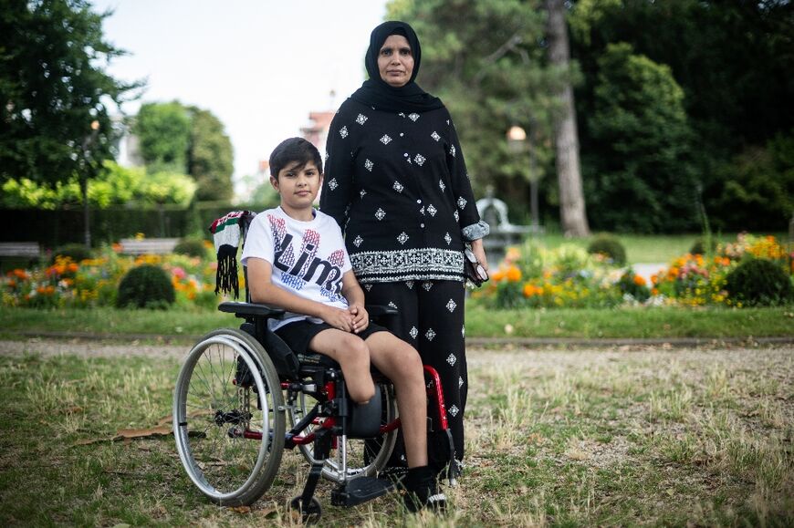Raja Abdulkareem Abu Mhadi, 47, brought her son Asef, 12, to France for treatment, but she is wracked with worry about her five other children