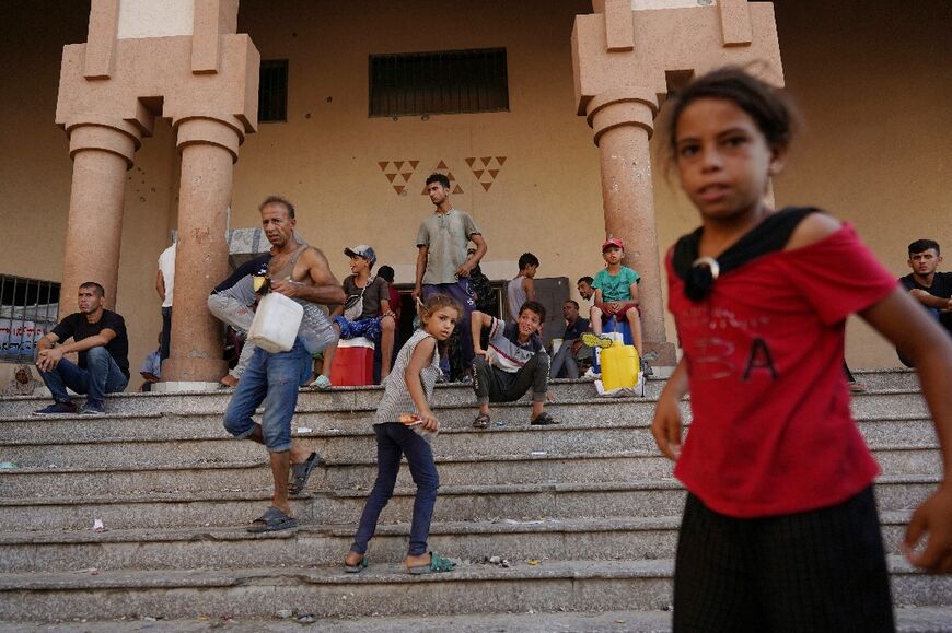 Palestinians at the entrance to a prison turned displacement shelter in Khan Yunis in the southern Gaza Strip