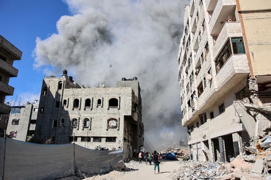 Smoke rises from a building hit by an Israeli strike after a warning from the Israeli army, in Gaza City