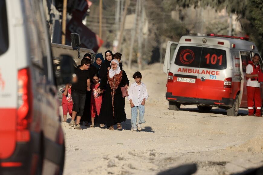 A Palestinian family flees an Israeli raid in the Nur Shams camp near the city of Tulkarem in the Israeli-occupied West Bank