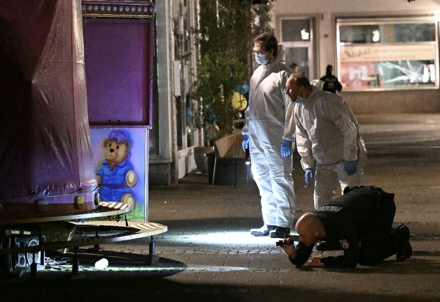 Police inspect the scene in Solingen after a man stabbed to death three people and wounded eight others at a street festival in the western city 