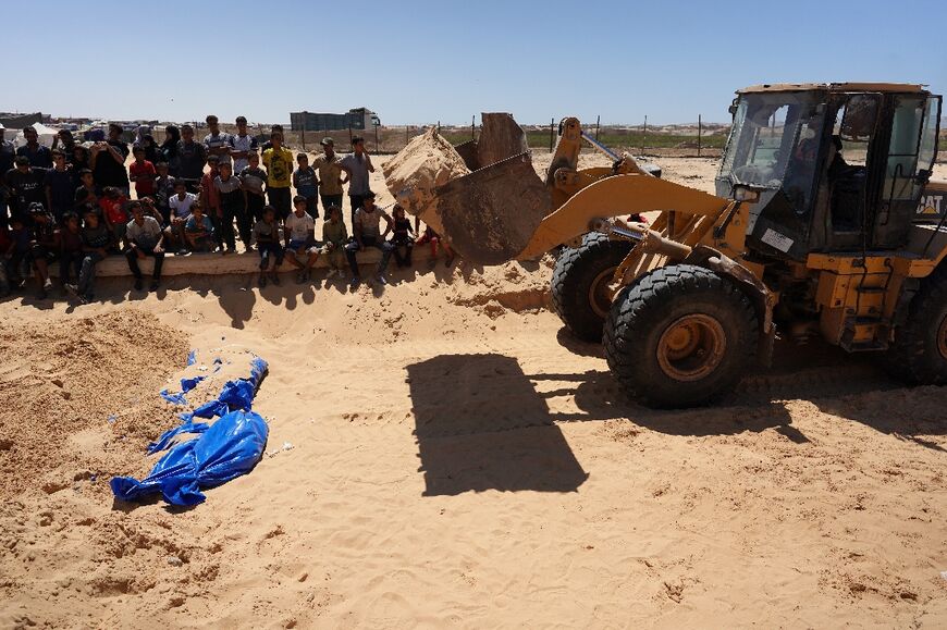 Gaza's Civil Defence agency said it received the bodies of 80 unidentified Palestinians from Israel -- they were buried in a mass grave near Khan Yunis, southern Gaza