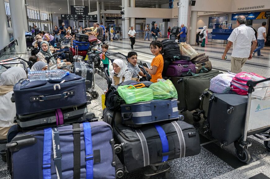 Passengers waiting at Beirut's international airport, after various countries warned their citizens to leave Lebanon