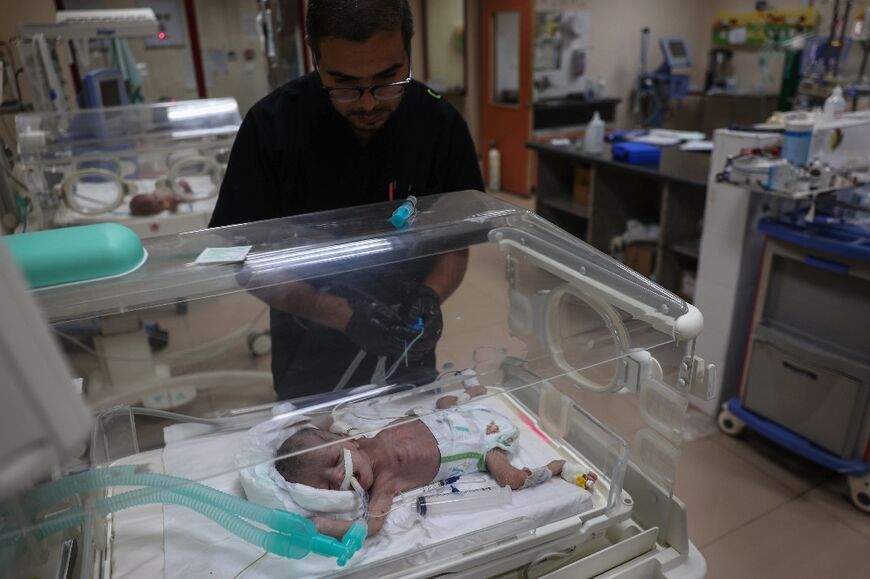 A Palestinian medic prepares to evacuate premature babies from the Al-Aqsa hospital in Deir el-Balah