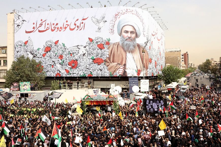 Iranians take part in a funeral procession of late Hamas leader Ismail Haniyeh in Tehran, ahead of burial in Doha