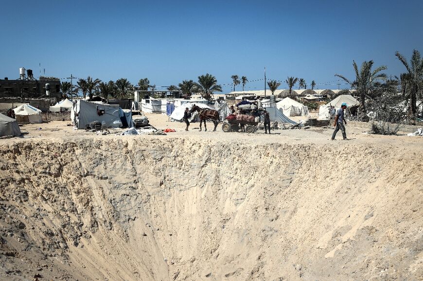 The edge of a crater caused by Israeli strikes on a makeshift displacement camp in Al-Mawasi in the southern Gaza Strip