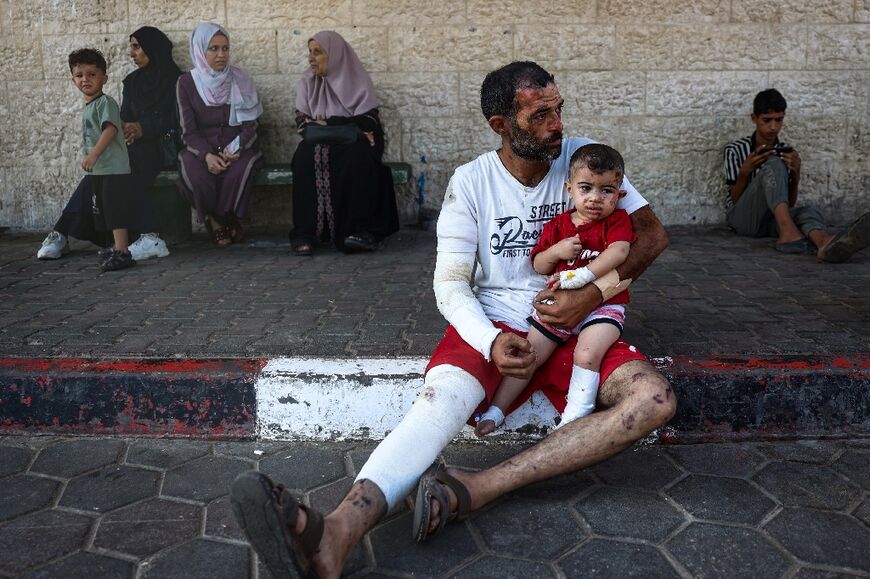 Ahmad Yunis and his son Sami, 3, both injured in the Bureij refugee camp, at Al-Aqsa Martyrs Hospital in Deir al-Balah in central Gaza