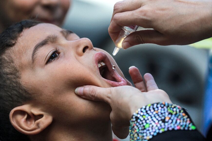 A child receives vaccination for polio in Khan Yunis in the southern Gaza Strip