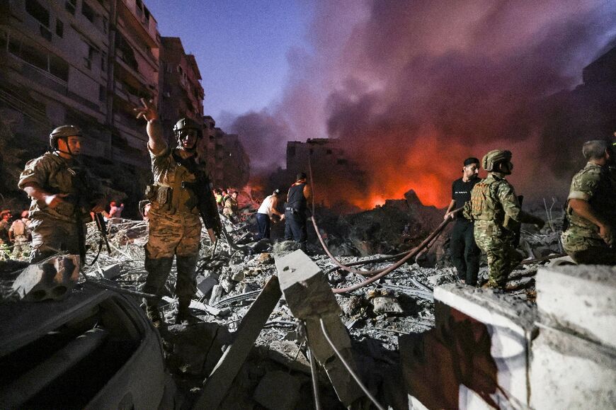 Lebanese soldiers gather over the rubble of a levelled buildings, following Israeli air strikes in the Haret Hreik neighbourhood of Beirut's southern suburbs