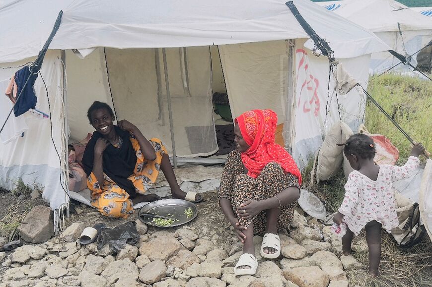 Displaced Sudanese in front of their tent at a United Nations Refugee Agency (UNHCR) camp in Gallabat on the Ethiopian border -- the UN says millions of people have been uprooted by Sudan's war