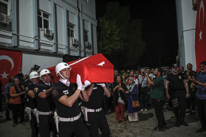 An honour guard carries the coffin of activist Aysenur Ezgi Eygi, who was killed in the West Bank, to a morgue after her remains arrived in Turkey on Friday