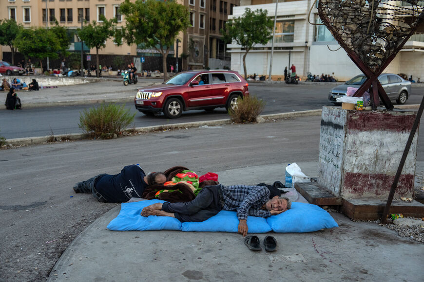 BEIRUT, LEBANON - SEPTEMBER 29: Men sleep in Martyrs' Square after being displaced by Israeli airstrikes, on September 29, 2024 in Beirut, Lebanon. Hezbollah, the Iran-backed Lebanese militant and political group, confirmed that its longtime leader Hassan Nasrallah was killed in an Israeli strike on Sept. 27 in its stronghold in Dahieh, a southern suburb of Beirut. Israel has launched further strikes against alleged Hezbollah targets in Lebanon in the days since, marking a sharp escalation of the current co