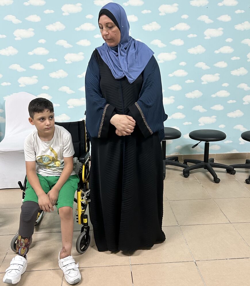 Siraj, who lost a limb during an attack visits the prosthetics center with his grandmother. Photo credit: Jennifer Gnana