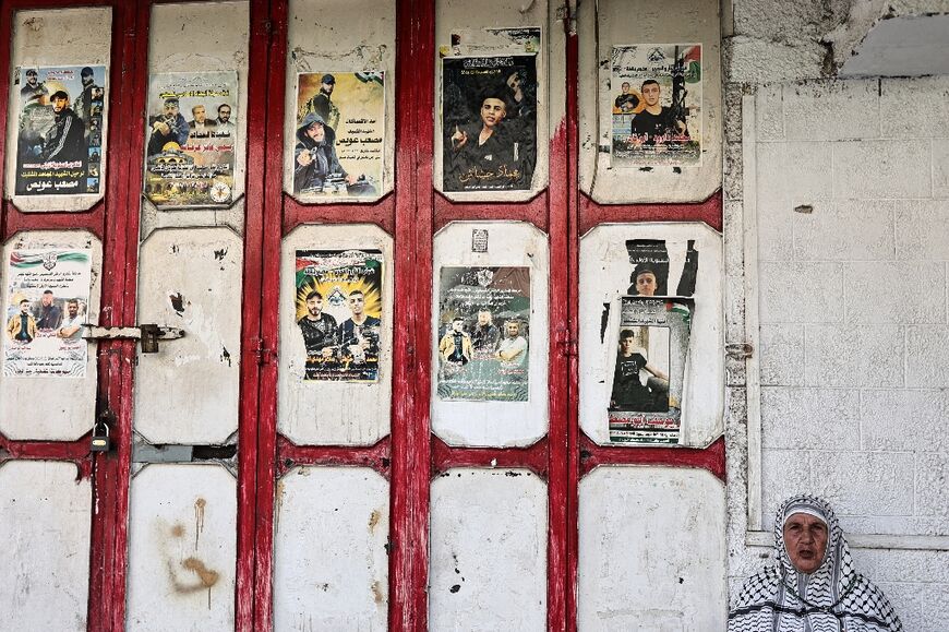 Memorial photographs of slain Palestinians posted on walls around the camp show Masha brandishing an automic weapon