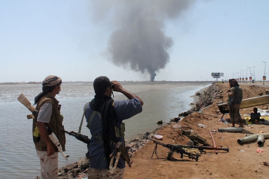 Smoke billows on the horizon during fighting near the southern Yemeni port of Aden in 2015