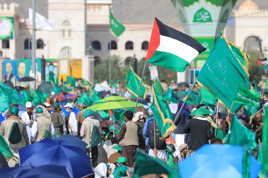 A supporter of Yemen's Huthi rebels waves a Palestinian flag at a rally in Sanaa to commemorate Prophet Mohammed's birth