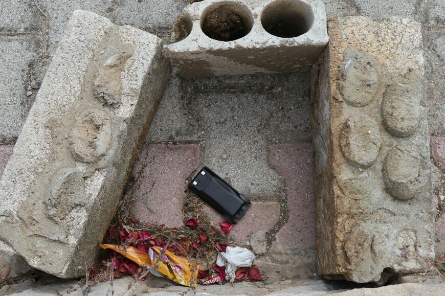 A communication device lies on the ground as Lebanese army forces (not pictured) prepare to destroy it in a controlled explosion, in southern Lebanon between the villages of Burj al-Muluk and Klayaa