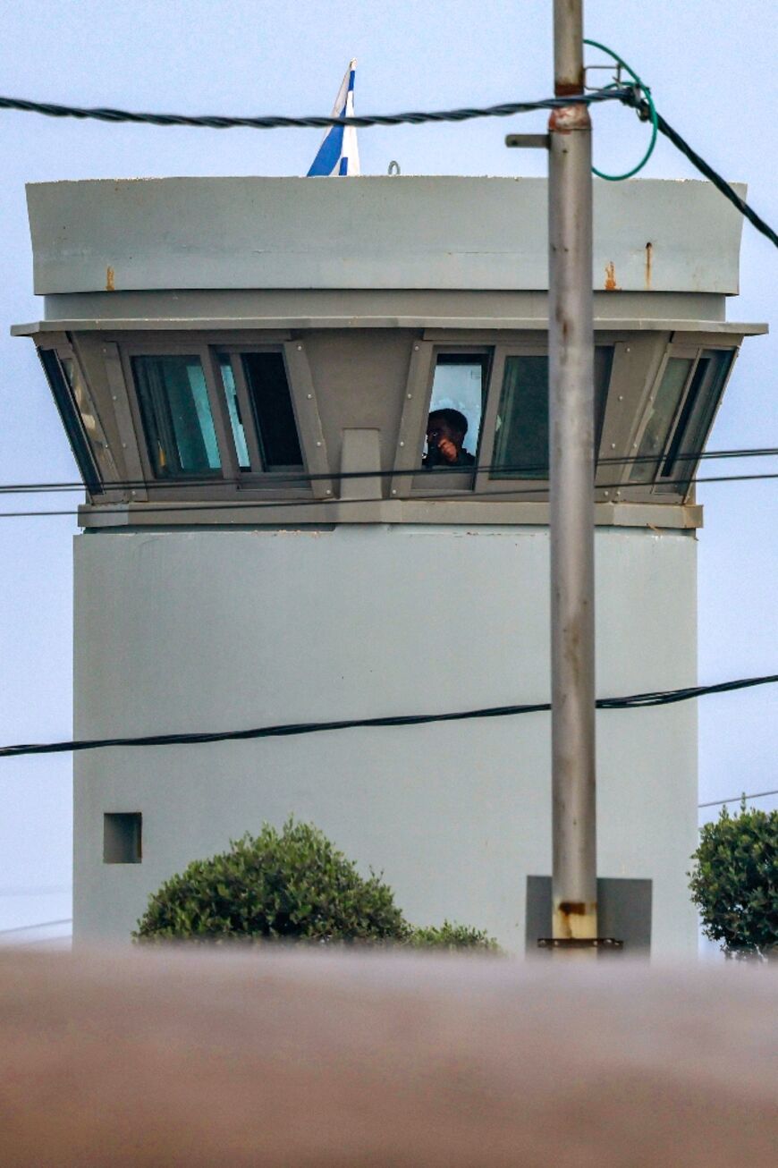 An Israeli soldier mans a watchtower overlooking the road into the West Bank town of Azzun where Tariq Daoud was killed