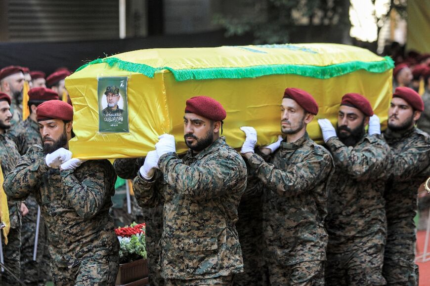 Hezbollah pall-bearers carry the coffin of Radwan Force commander Ibrahim Aqil