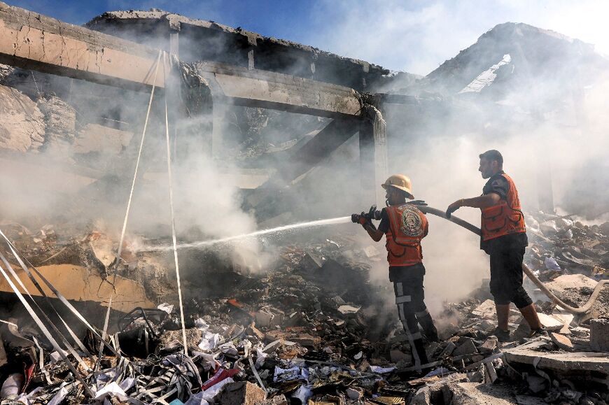 Palestinians try to extinguish a fire in a building that was hit by Israeli strikes in Gaza's Sheikh Radwan neighbourhoods on September 3, 2024