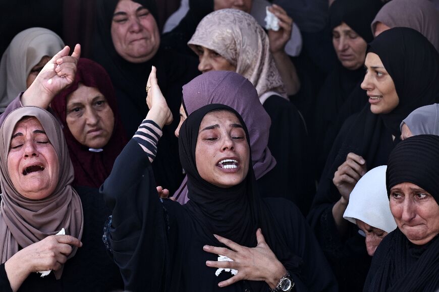 Relatives of Shadi Zakarneh mourn during his funeral in Qabatiyah