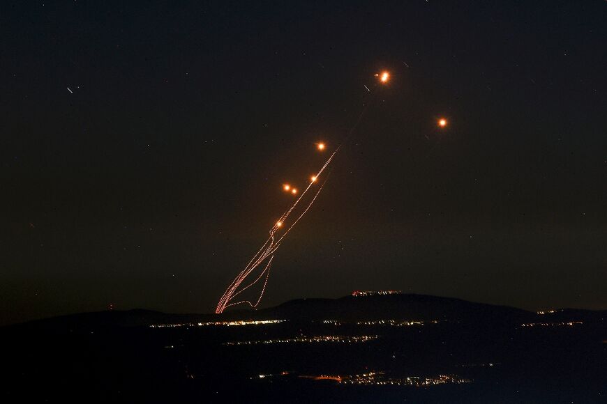 Rockets fired from southern Lebanon are intercepted by Israel's Iron Dome air defence system over the Upper Galilee region