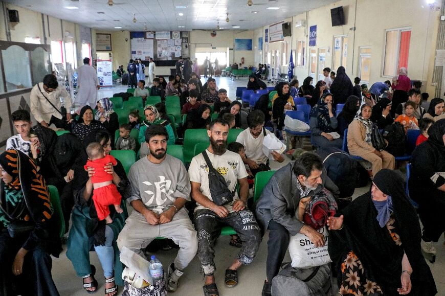 Afghan refugees wait for registration after their deportation from Iran, at a registration centre near the Afghanistan-Iran border in the Islam Qala district of Herat province