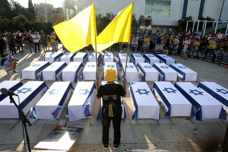 Demonstrators display coffins during an anti-government protest in Tel Aviv