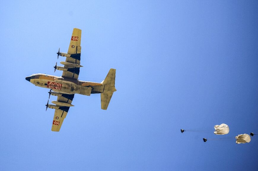 A Jordanian military aircraft drops humanitarian aid on Khan Yunis in the southern Gaza Strip