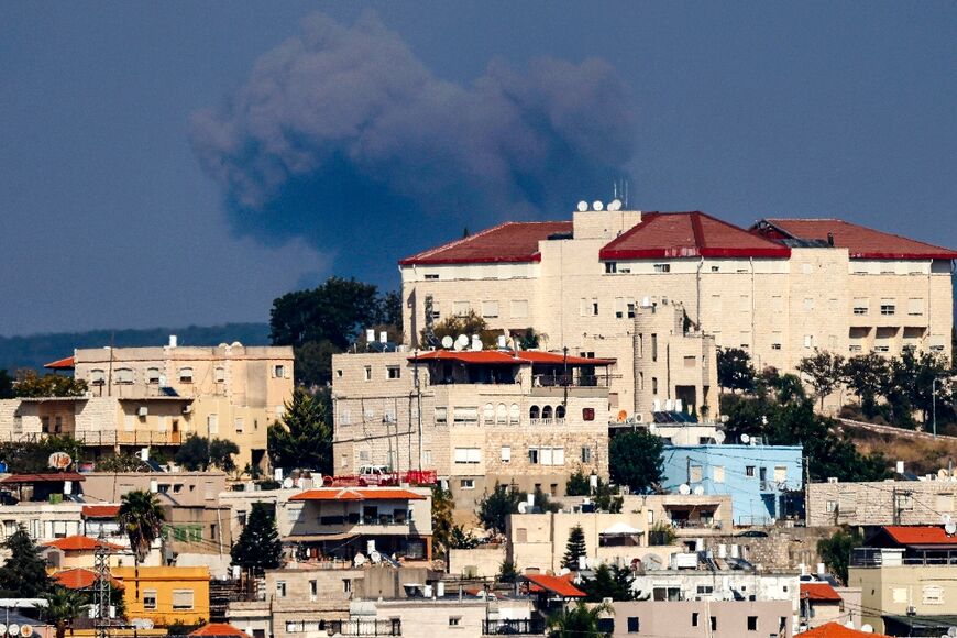 Smoke billows on the Lebanese side of the border following an Israeli air strike, seen from the northern Israeli town of Miilya in the western Galilee 