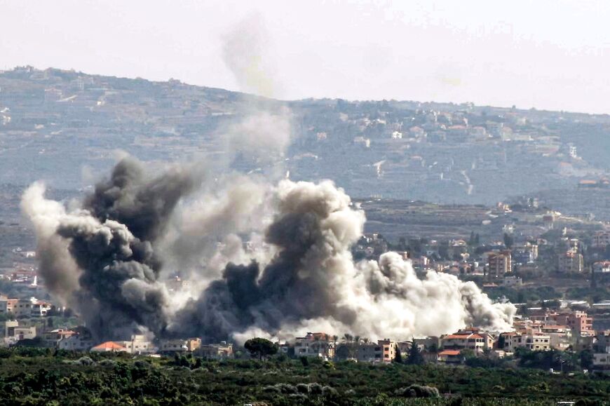 Seen from Lebanon's southern city of Tyre, smoke billows after an Israeli air strike on the village of Deir Qanoun 