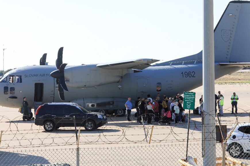 People get ready to board a Slovak Air Force plane at Beirut International Airport -- many nations are flying out their citizens from war-torn Lebanon