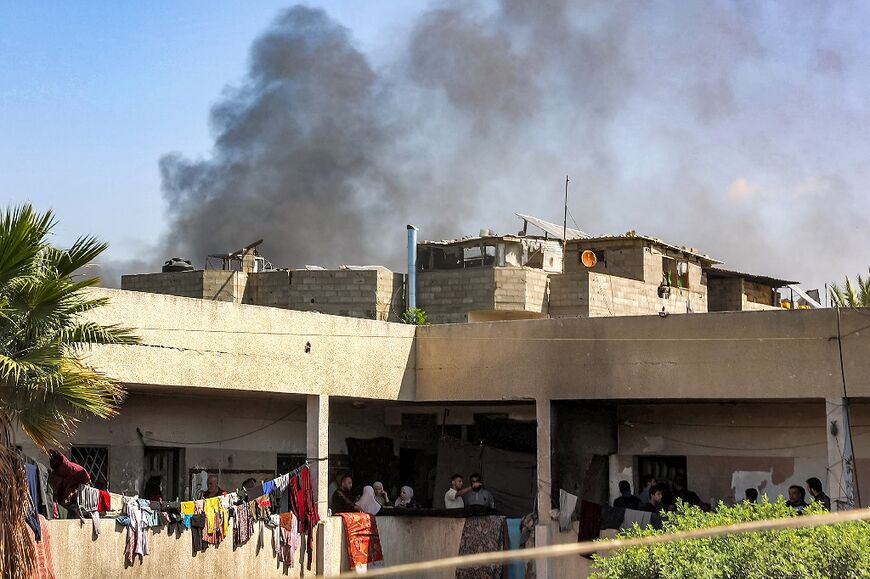 Smoke billows behind the Rafei school serving as a displacement shelter in Jabalia camp for Palestinian refugees, north Gaza