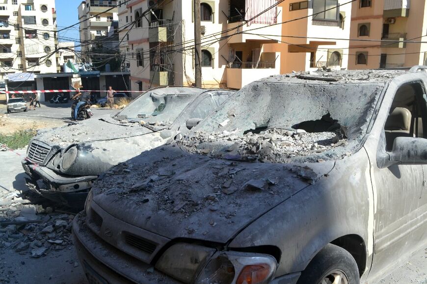 Damaged cars in a cordoned-off area of north Lebanon's Palestinian refugee camp of Beddawi after an Israeli strike