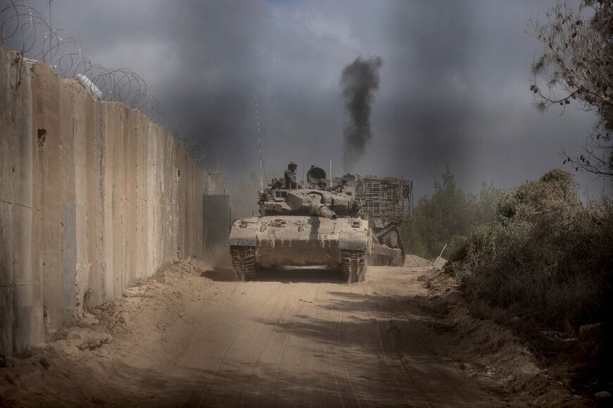 An Israeli battle tank is seen entering Lebanon from northern Israel at the southern Lebanese border point of Naqoura