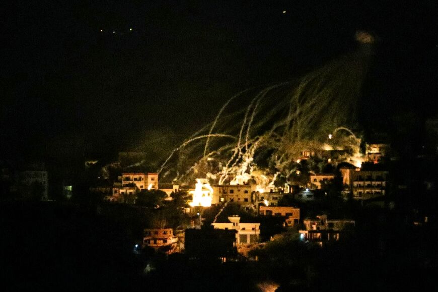 Explosions over buildings in the town of Khiam, southern Lebanon, during Israeli bombardment 