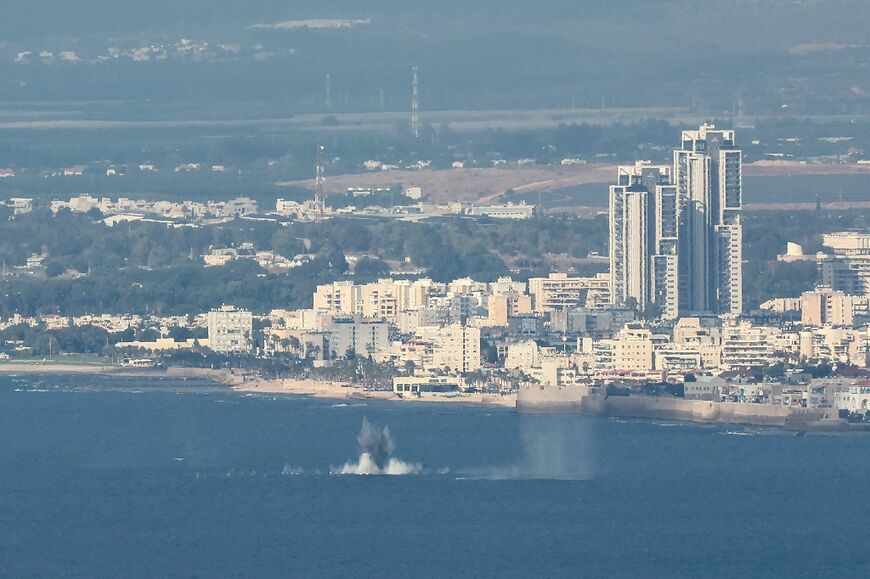 The remains of projectiles intercepted by Israeli air defence systems fall into the Mediterranean Sea near the city of Haifa, northern Israel