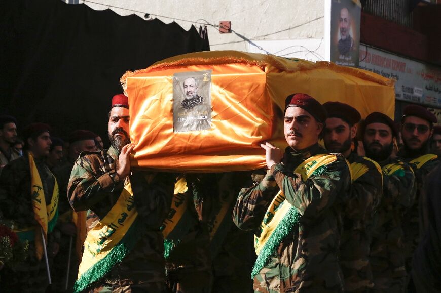 Hezbollah fighters carry the coffin of Mohammed Srur, head of the movement's drone unit, killed on September 26, 2024 in an Israeli strike on Beirut's southern suburbs