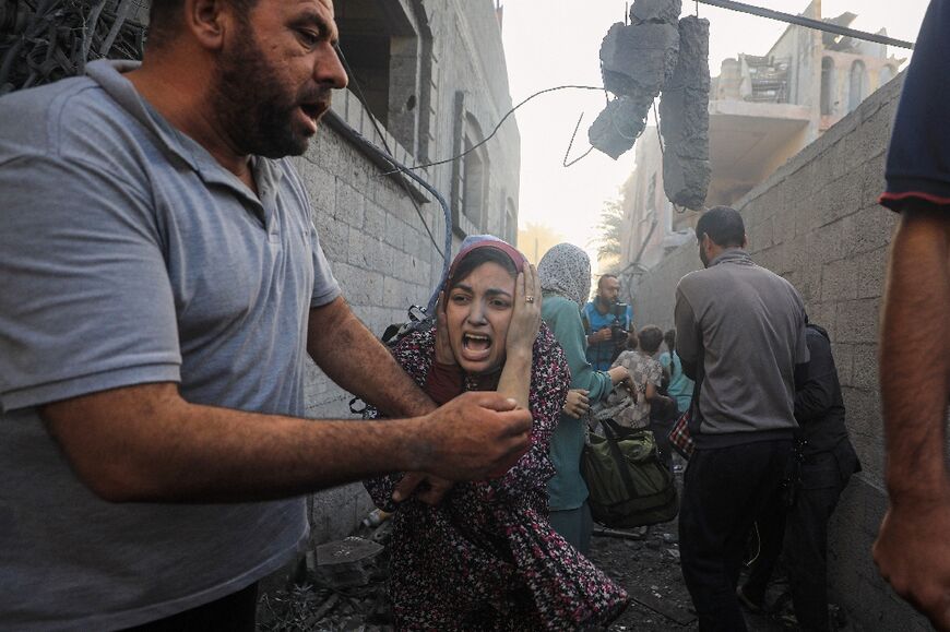 People flee following Israeli air strikes on a neighbourhood in the al-Maghazi refugee camp, central Gaza, on November 6, 2023