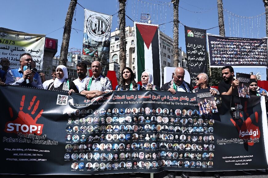 In Ramallah, in the West Bank, protesters carried a banner showing photos of slain Palestinian journalists