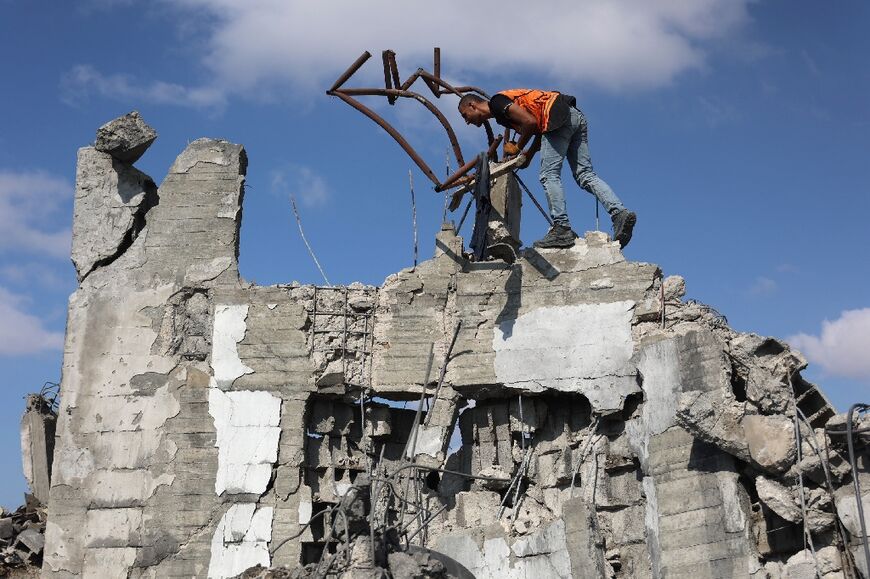 A Palestinian medic searches for survivors in the rubble of a building after it was hit during an Israeli strike on Gaza City's Zeitun neighbourhood