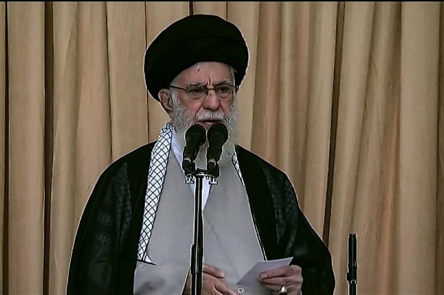 Iran's supreme leader Ayatollah Ali Khamenei delivers a rare Friday prayer sermon in Tehran, a rifle to his left