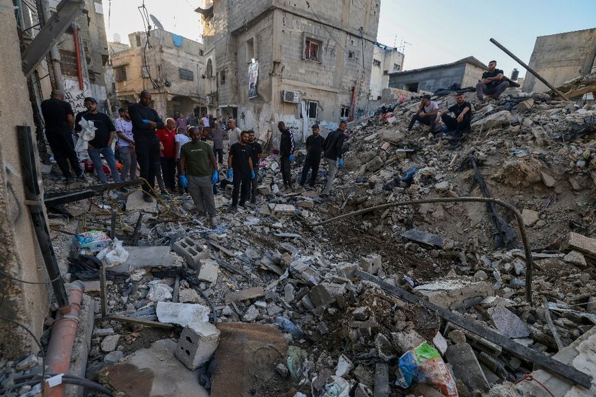 Palestinians inspect the damage from an Israeli air strike on Tulkarem refugee camp, which a security source said was the deadliest in the occupied West Bank since 2000 with 18 people killed