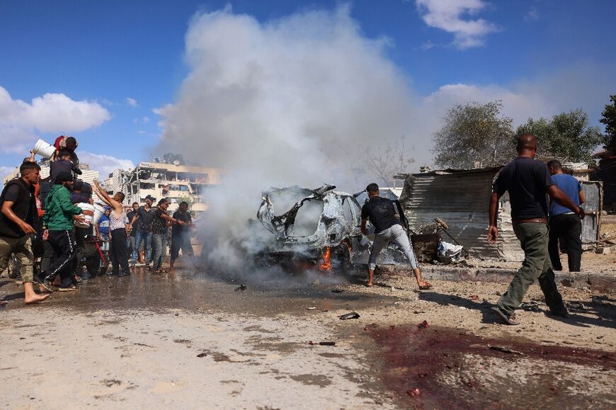 Palestinians at the site of an Israeli strike in Gaza's southern Khan Yunis on October 1